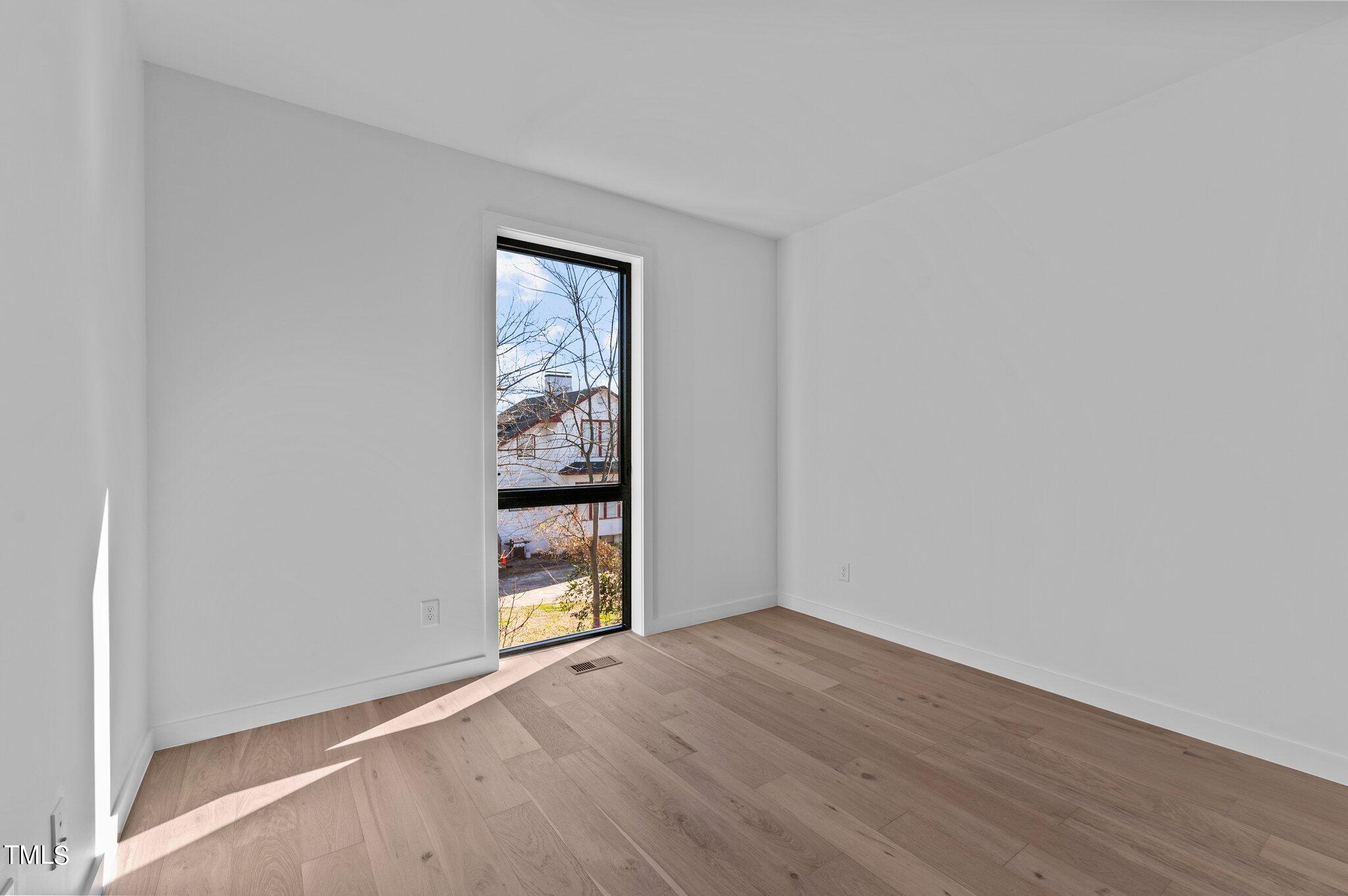 819 South Person Street Raleigh, NC 27601 - Photo 21 of 33 a view of an empty room with a window and wooden floor