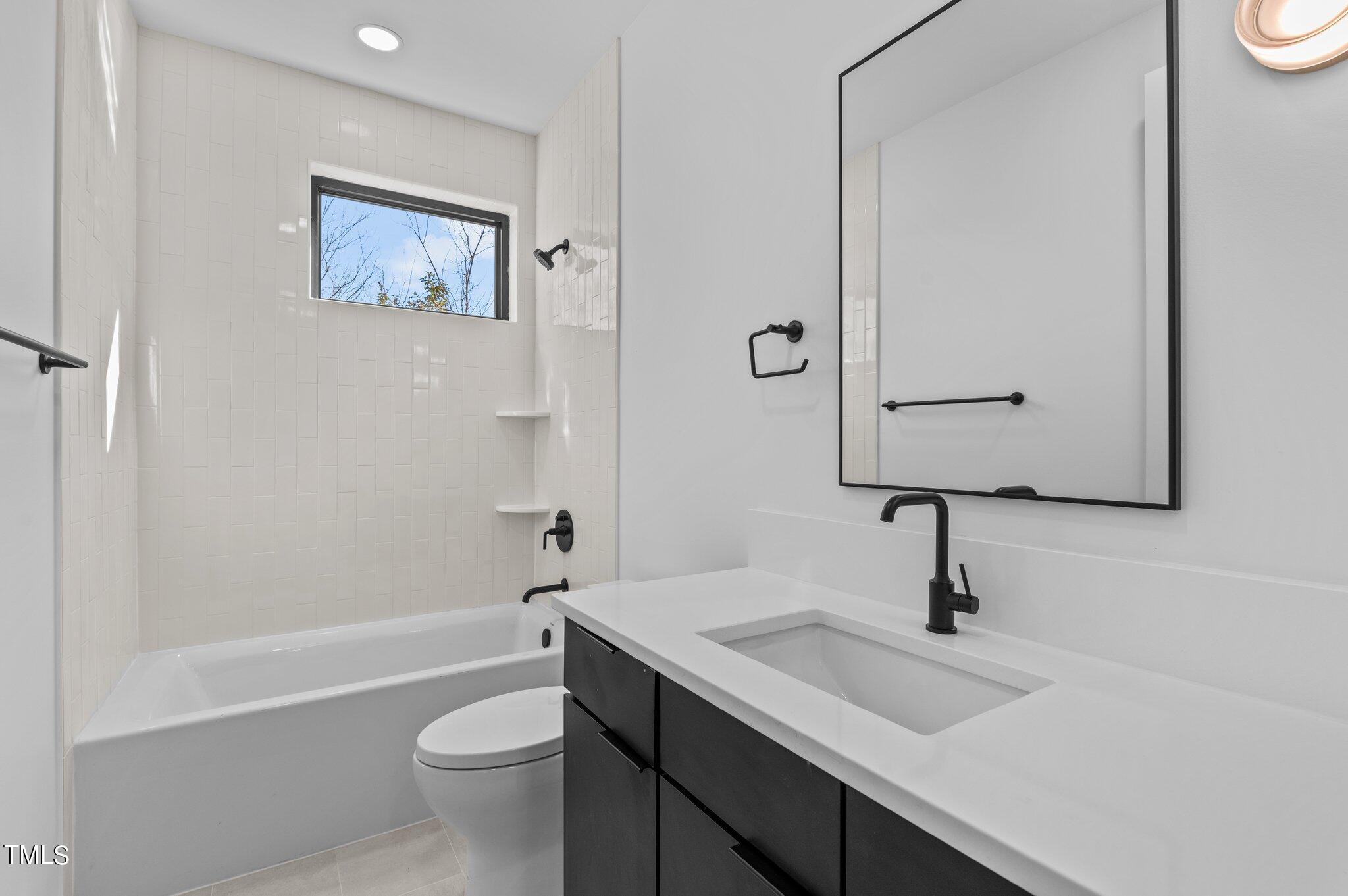 819 South Person Street Raleigh, NC 27601 - Photo 22 of 33 a bathroom with a toilet sink and mirror