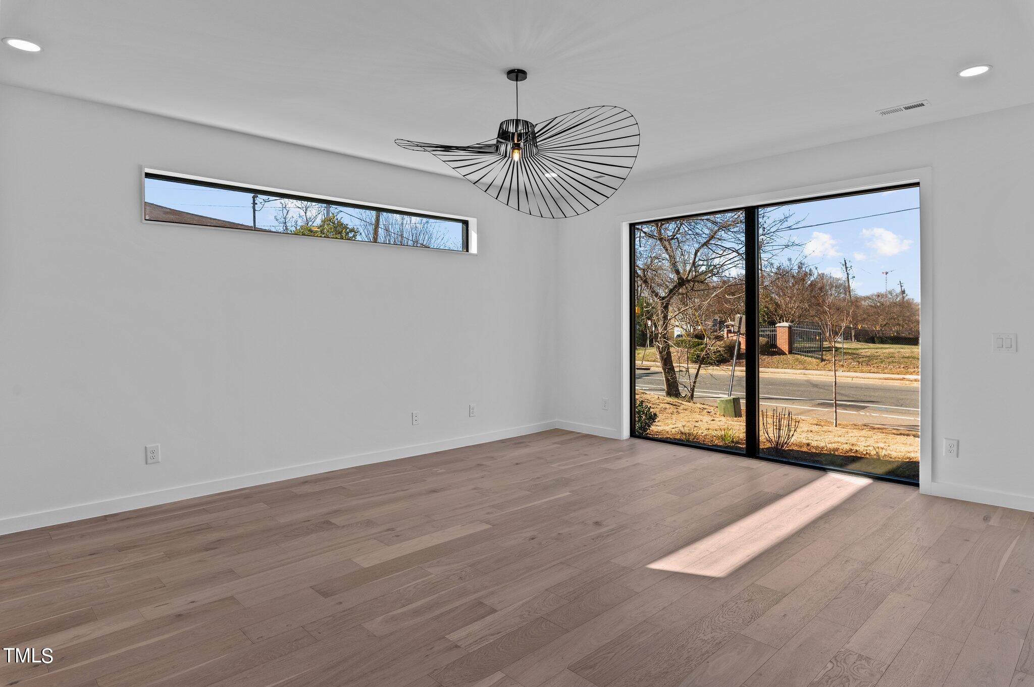 819 South Person Street Raleigh, NC 27601 - Photo 5 of 33 a view of empty room with wooden floor and fan