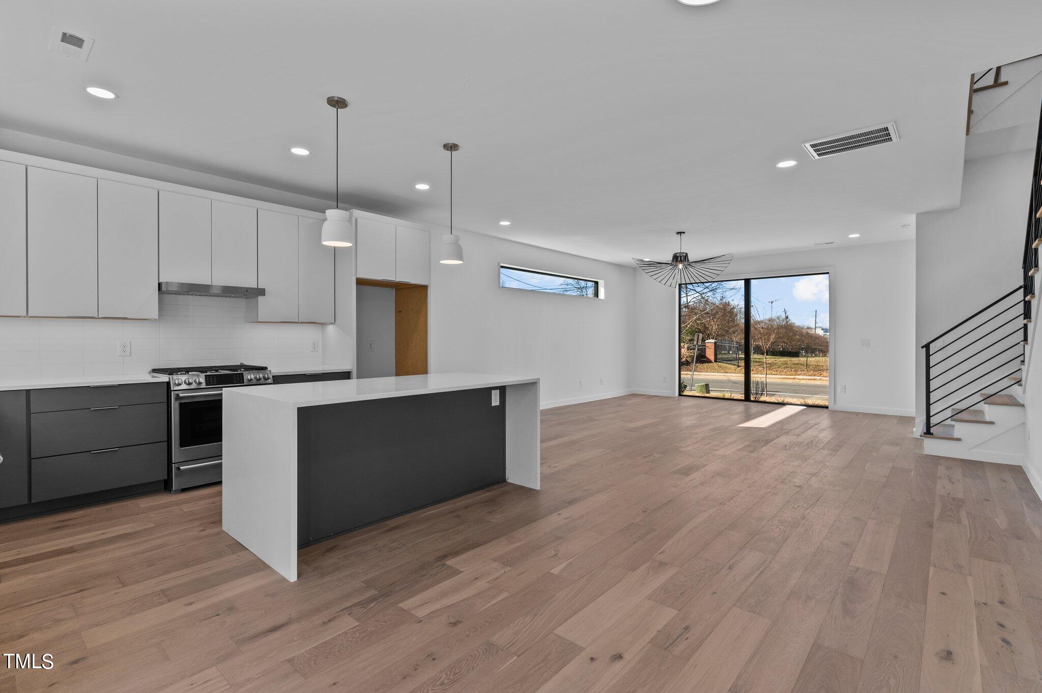 819 South Person Street Raleigh, NC 27601 - Photo 33 of 33 a large kitchen with stainless steel appliances granite countertop a large counter top and a stove top oven