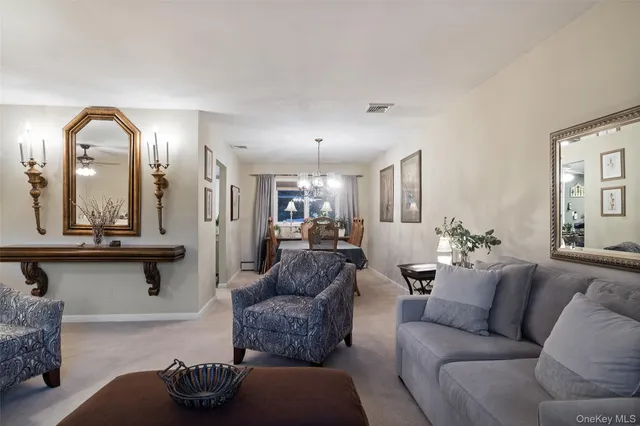 a living room with furniture and a large mirror