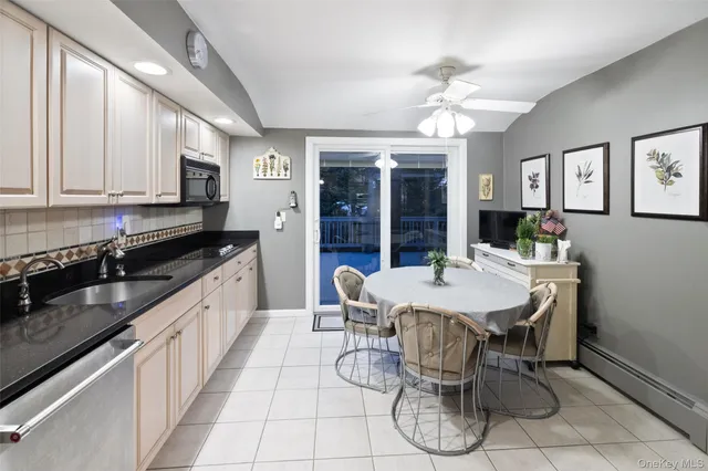 a kitchen with stainless steel appliances granite countertop a sink a stove a counter space and dining table
