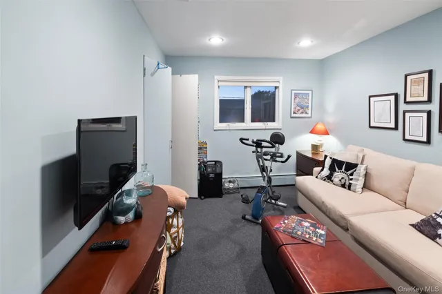 a living room with furniture stairs and a window
