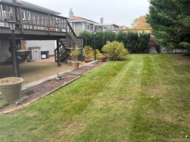 a view of a patio with table and chairs and potted plants