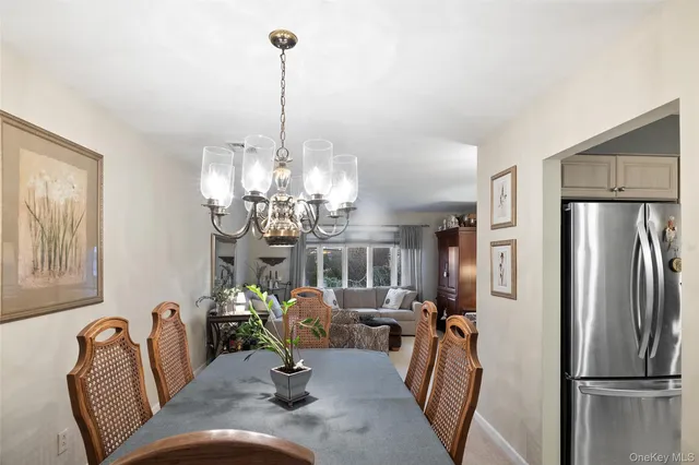 a view of a dining room with furniture a chandelier and wooden floor