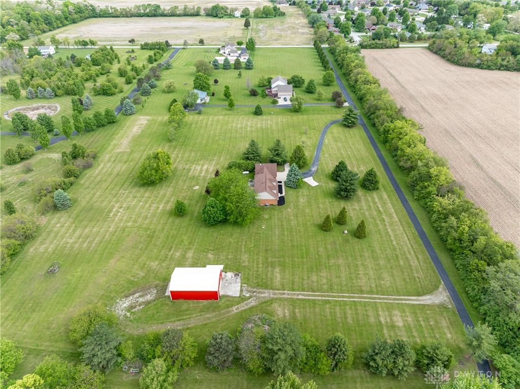 9981 Ridge Acres Lane Englewood, OH 45322 - Photo 52 of 73 Expansive green acreage with private residences and agricultural fields create a picturesque rural setting.