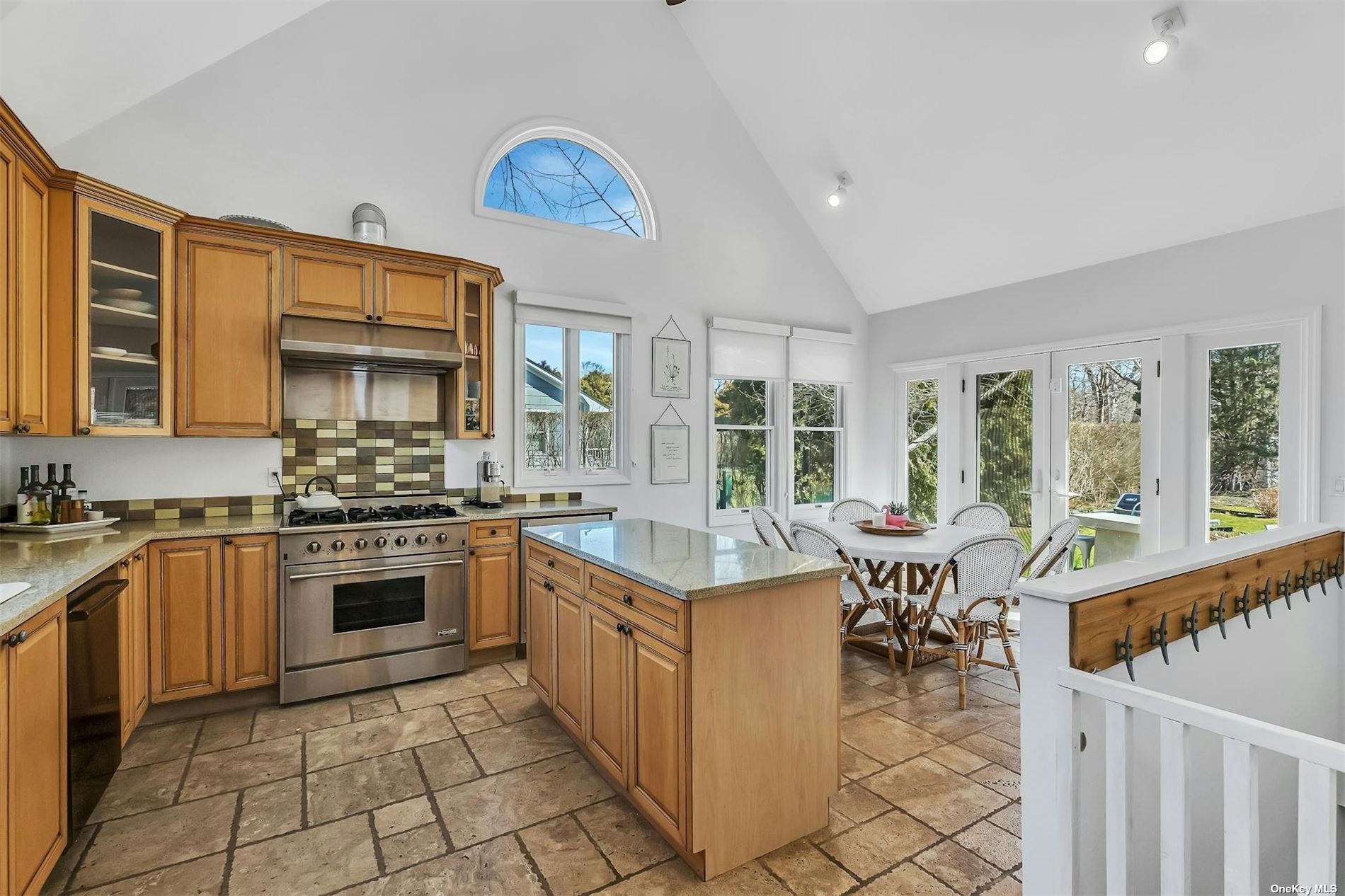 6 Remsenburg, undefined 00000 - Photo 9 of 31 a kitchen with stainless steel appliances granite countertop a stove top oven a sink dishwasher a dining table and chairs with wooden floor