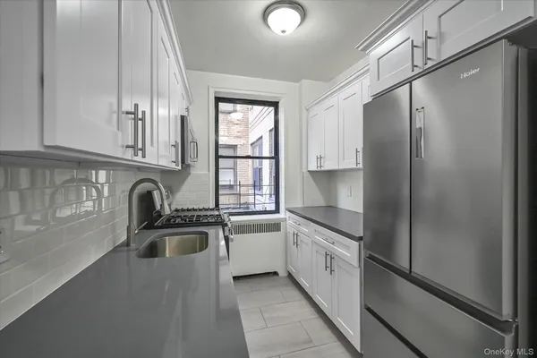 a kitchen that has a sink and a stove