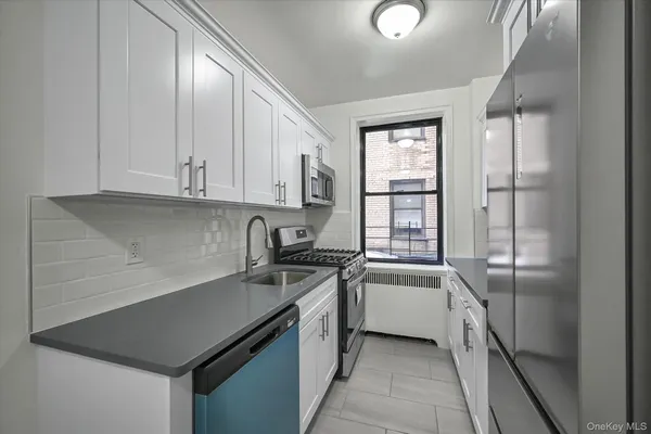 a kitchen with granite countertop a sink and cabinets
