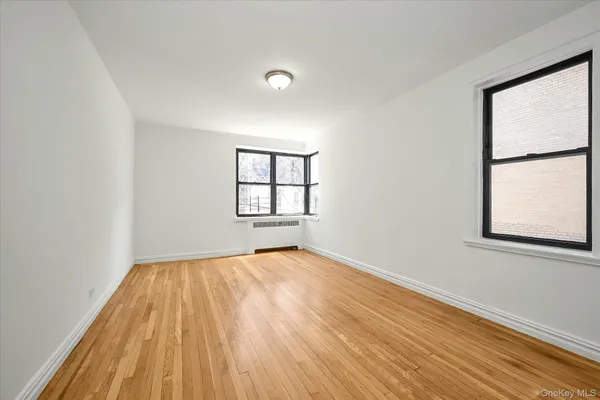 a view of a room with wooden floor