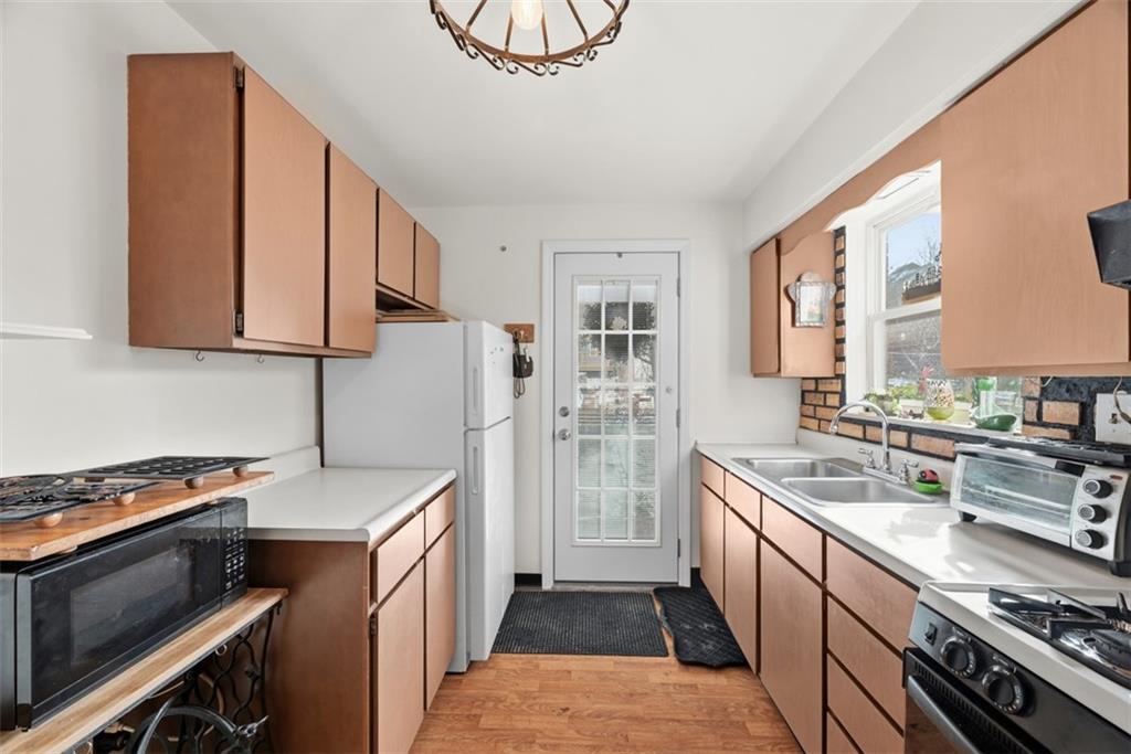 7210 Raymond Street Pittsburgh, PA 15218 - Photo 11 of 37 a kitchen with a sink stove and cabinets