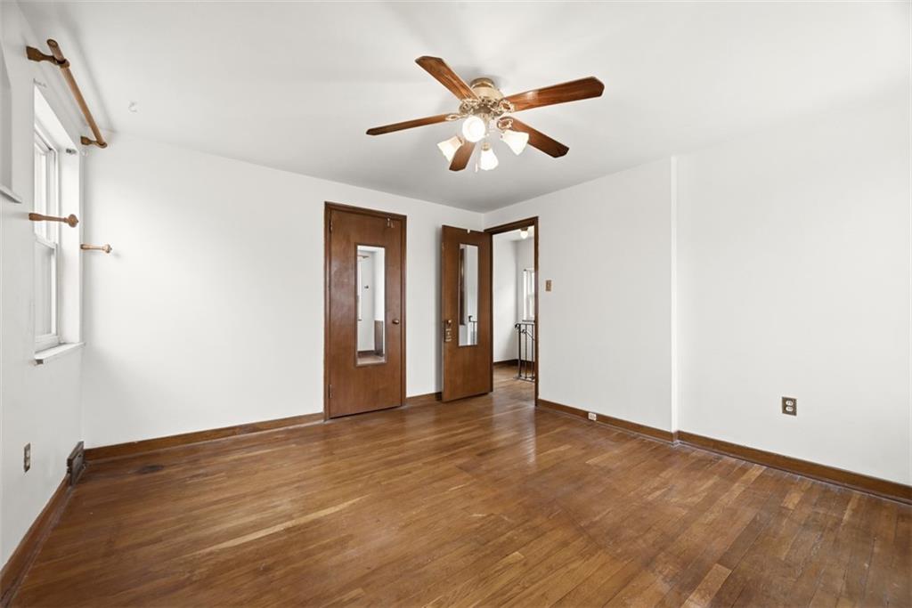7210 Raymond Street Pittsburgh, PA 15218 - Photo 15 of 37 a view of an empty room with wooden floor