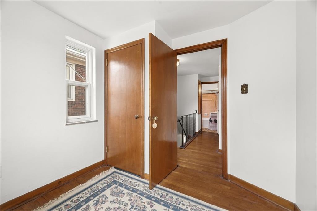 7210 Raymond Street Pittsburgh, PA 15218 - Photo 17 of 37 a view of a hallway with wooden floor and a living room