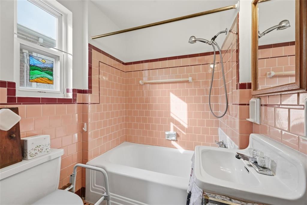 7210 Raymond Street Pittsburgh, PA 15218 - Photo 20 of 37 a bathroom with a sink mirror bathtub and toilet