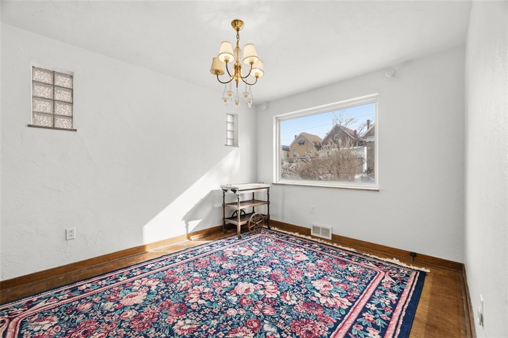 7210 Raymond Street Pittsburgh, PA 15218 - Photo 8 of 37 a view of an empty room with window and wooden floor