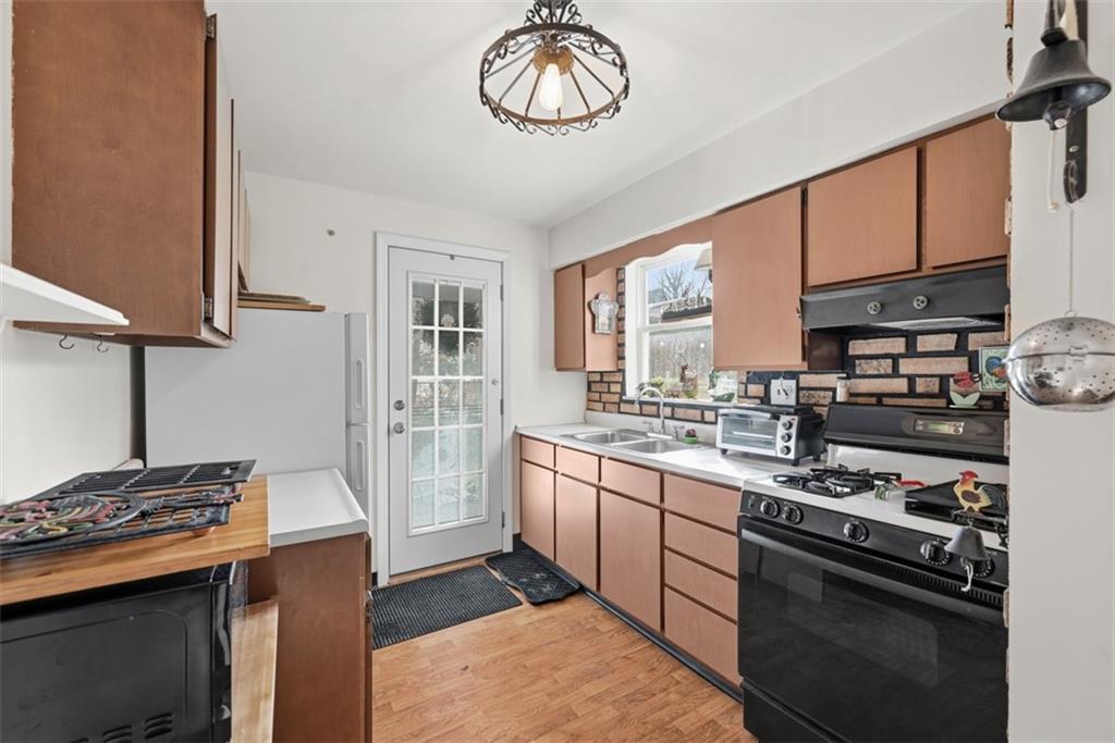 7210 Raymond Street Pittsburgh, PA 15218 - Photo 10 of 37 a kitchen with stainless steel appliances granite countertop a stove and a sink