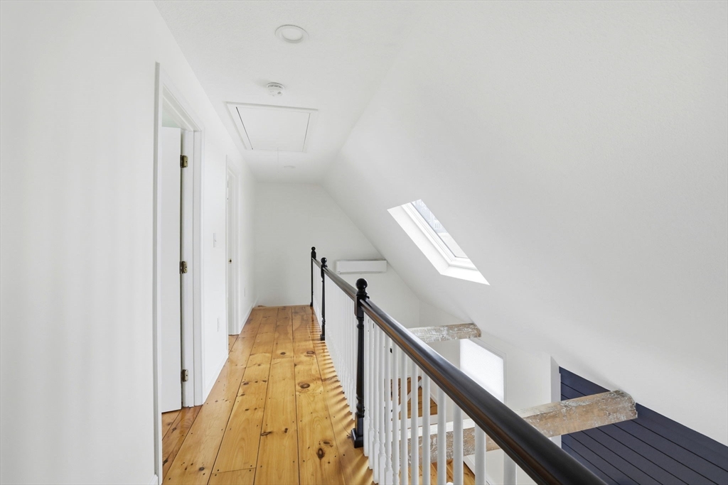 34 Flintlock Ridge Road Cohasset, MA 02025 - Photo 16 of 33 a view of a hallway with wooden floor and staircase