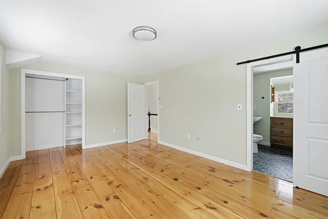 a view of a kitchen with furniture and wooden floor