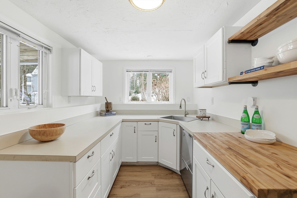 34 Flintlock Ridge Road Cohasset, MA 02025 - Photo 23 of 33 a kitchen with a sink dishwasher and white cabinets with wooden floor