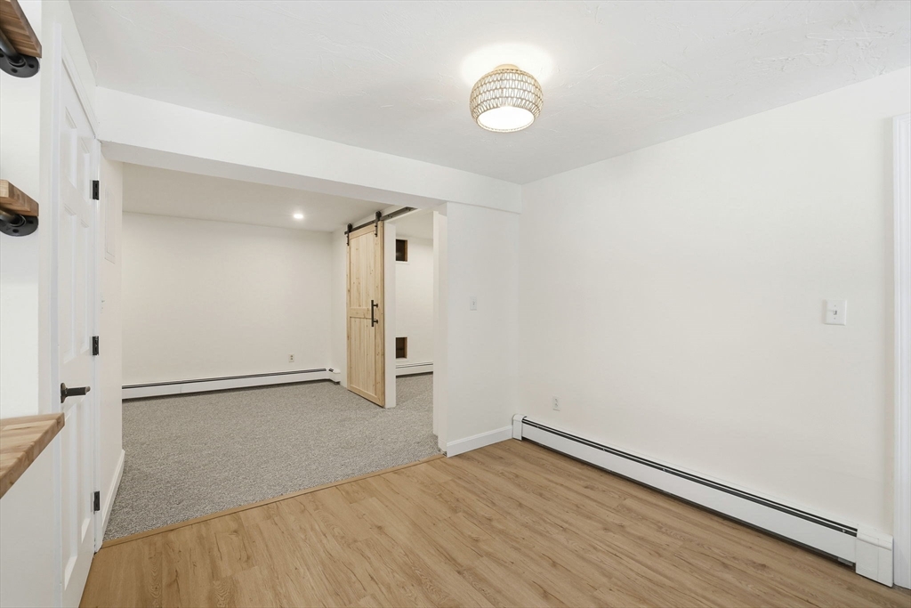 34 Flintlock Ridge Road Cohasset, MA 02025 - Photo 25 of 33 an empty room with wooden floor and windows