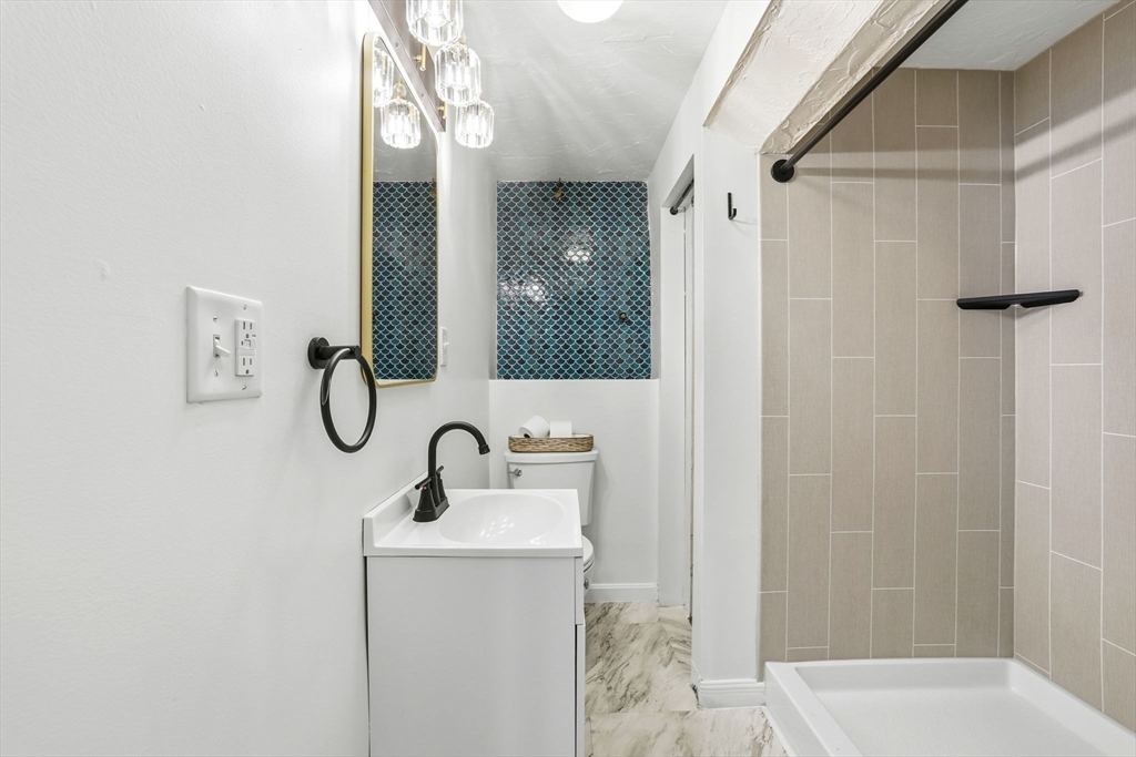 34 Flintlock Ridge Road Cohasset, MA 02025 - Photo 27 of 33 a bathroom with a sink a toilet and shower