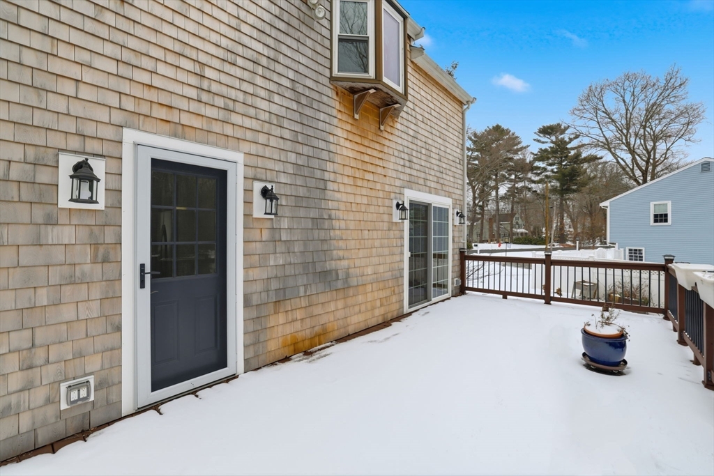 34 Flintlock Ridge Road Cohasset, MA 02025 - Photo 28 of 33 a view of a house with porch and wooden fence