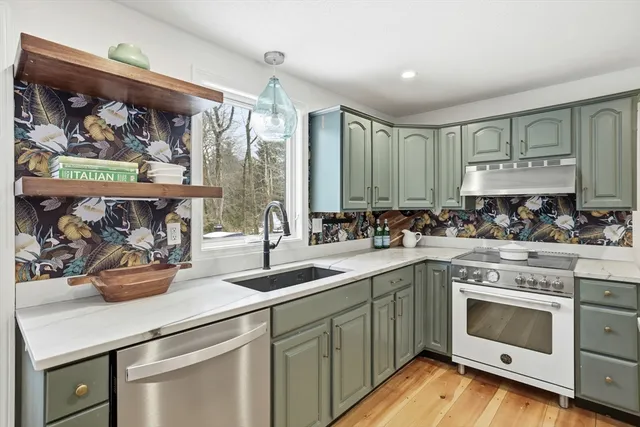 a kitchen with a refrigerator and cabinets