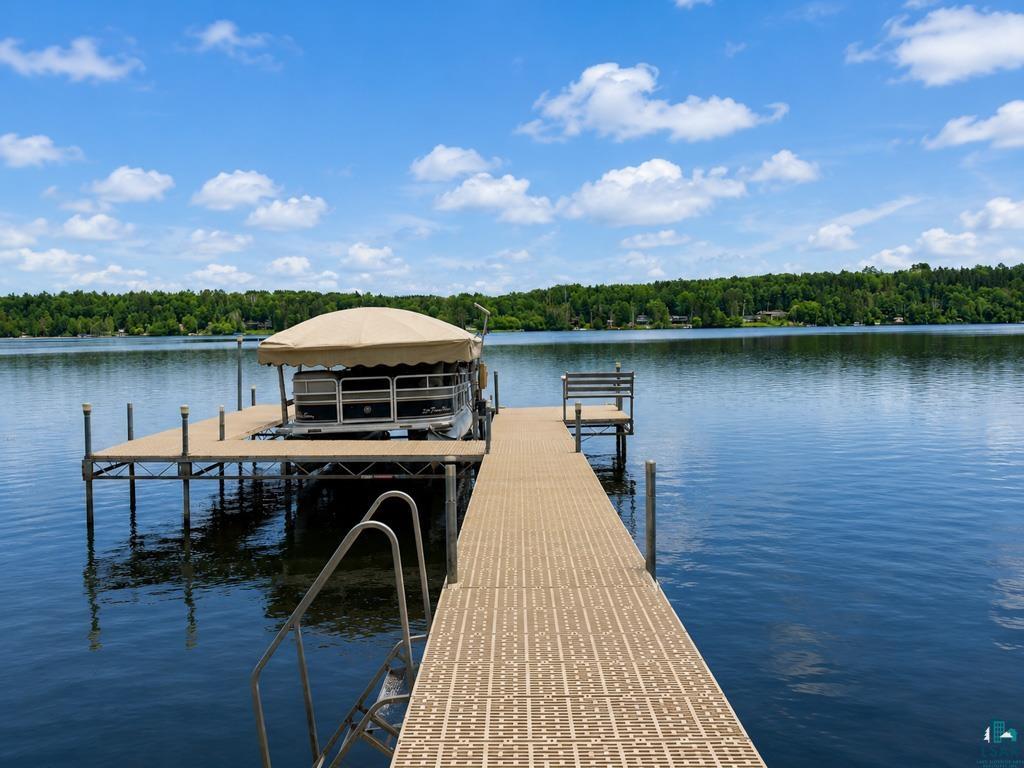 11058 South Brancel Road Solon Springs, WI 54873 - Photo 3 of 6 Expansive waterfront setting featuring a sturdy, composite dock with a boat lift, integrated seating, and water access ladder