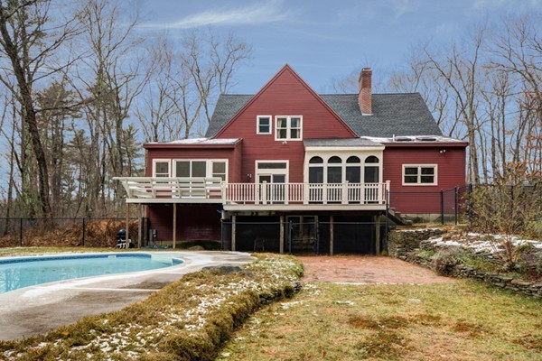 9 Crockett Road Upton, MA 01757 - Photo 3 of 22 a front view of a house with a yard covered with trees