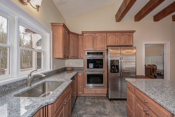 9 Crockett Road Upton, MA 01757 - Photo 9 of 22 a kitchen with granite countertop a sink stove and refrigerator