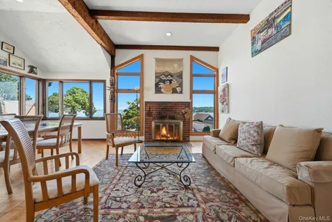 a living room with furniture a large window and a fireplace
