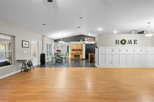 a large kitchen with a table and chairs