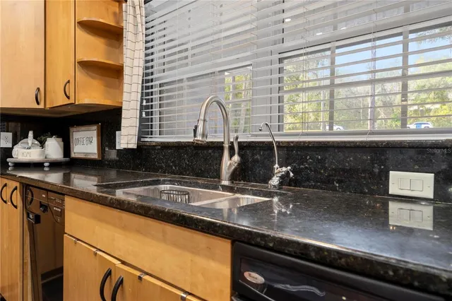 a large kitchen with a table and chairs