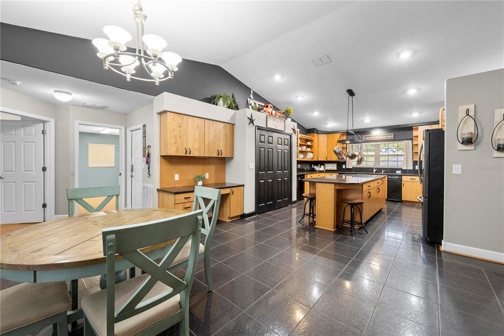 4244 Bessemer Road Brooksville, FL 34602 - Photo 20 of 56 a large kitchen with a table and chairs