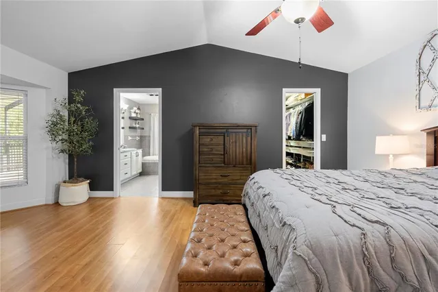 a bathroom with a granite countertop bathtub a sink and a large mirror