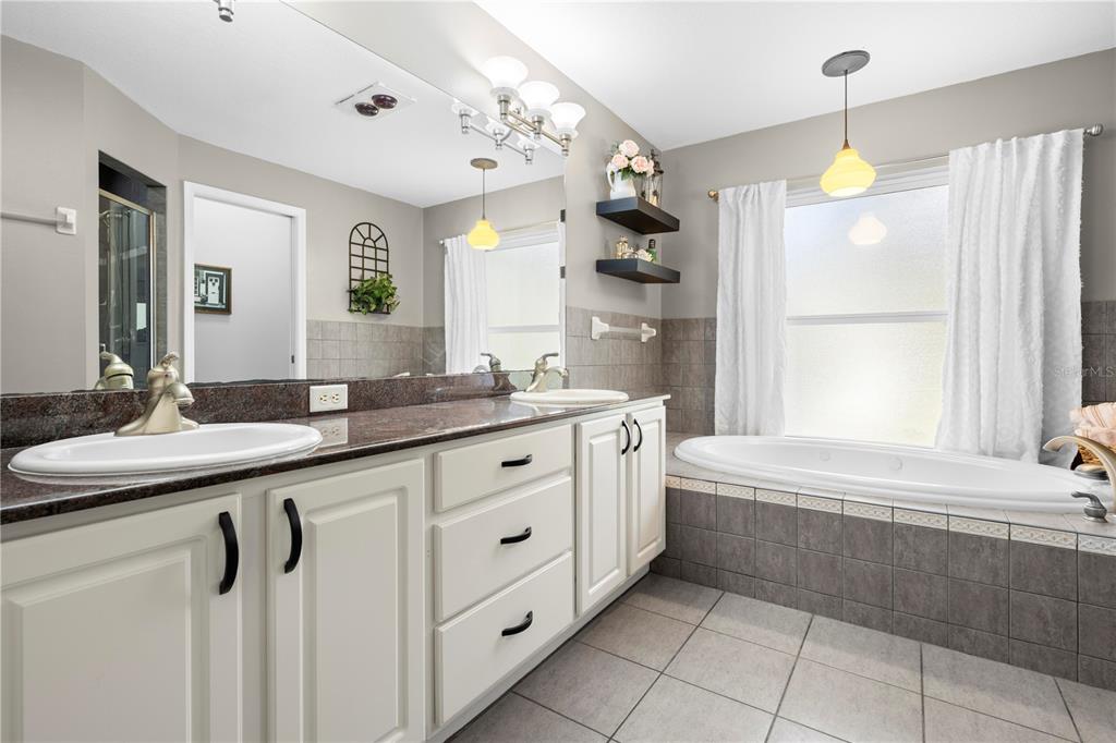 4244 Bessemer Road Brooksville, FL 34602 - Photo 29 of 56 a bathroom with a tub sink and mirror