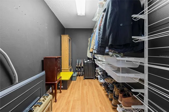 a bedroom with a large bed and a flat screen tv