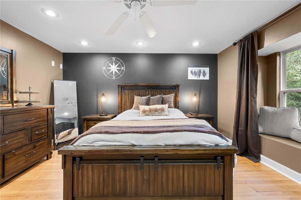 4244 Bessemer Road Brooksville, FL 34602 - Photo 35 of 56 a bedroom with a bed and chandelier