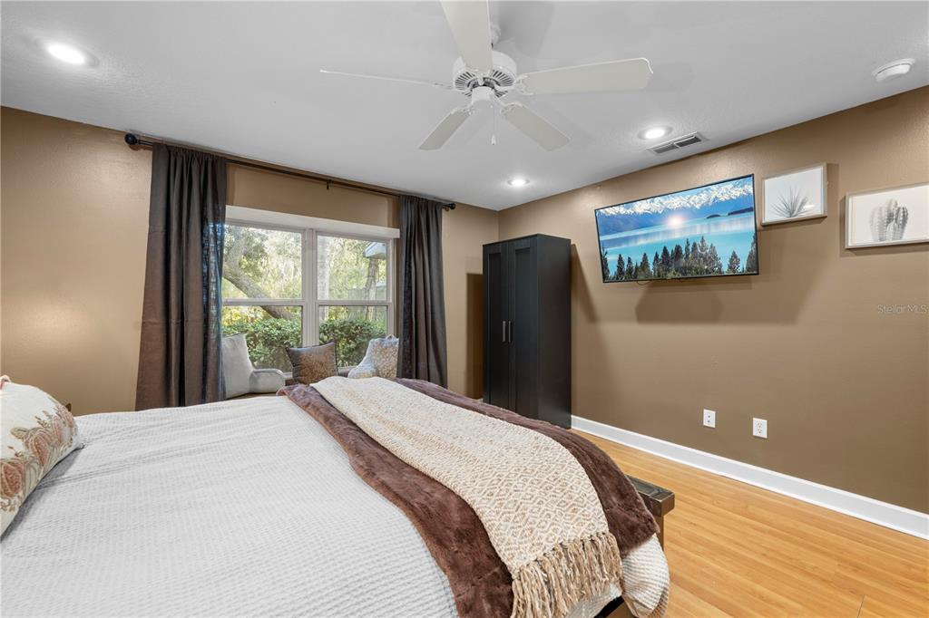 4244 Bessemer Road Brooksville, FL 34602 - Photo 36 of 56 a bedroom with a large bed and a flat screen tv