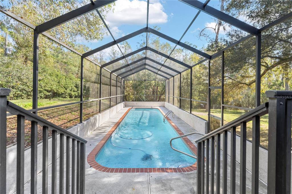 4244 Bessemer Road Brooksville, FL 34602 - Photo 50 of 56 a view of staircase with a small kitchen