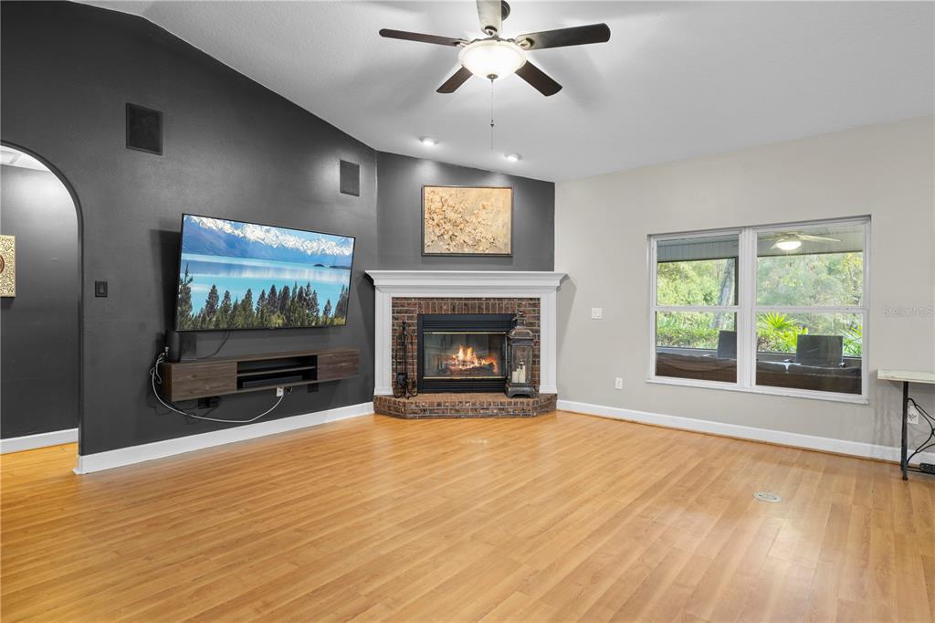 4244 Bessemer Road Brooksville, FL 34602 - Photo 7 of 56 a view of an empty room with a window and fireplace