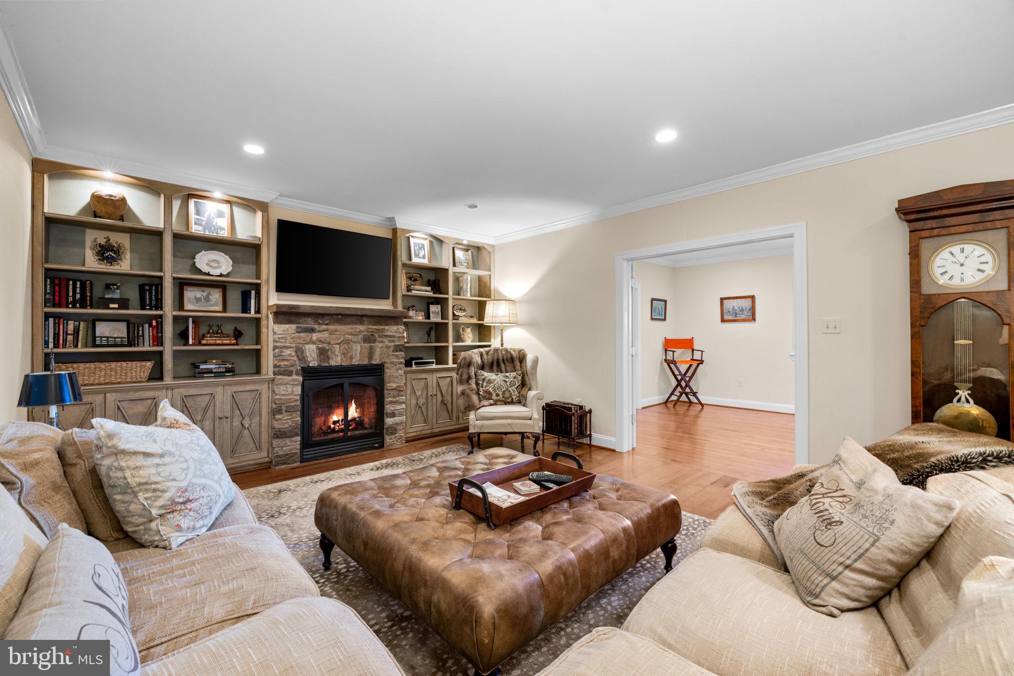 36190 Turkey Roost Road Middleburg, VA 20117 - Photo 69 of 88 a living room with furniture a fireplace and a flat screen tv
