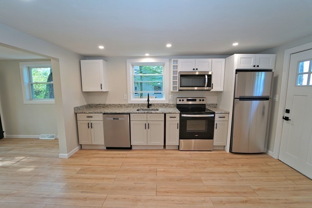 4 Juniper Road Holbrook, MA 02343 - Photo 6 of 27 a kitchen with granite countertop a refrigerator stove top oven and sink
