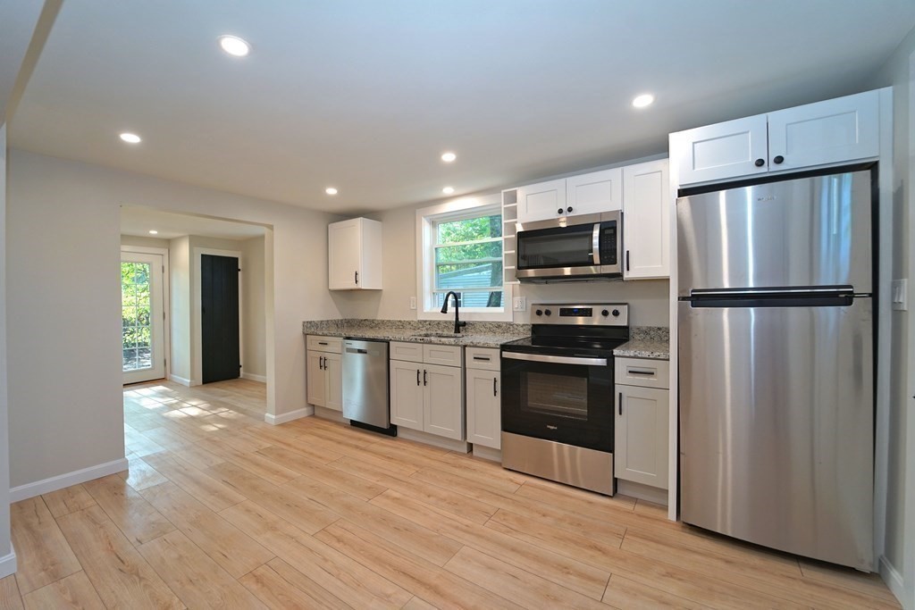 4 Juniper Road Holbrook, MA 02343 - Photo 8 of 27 a kitchen with granite countertop a refrigerator and a stove top oven