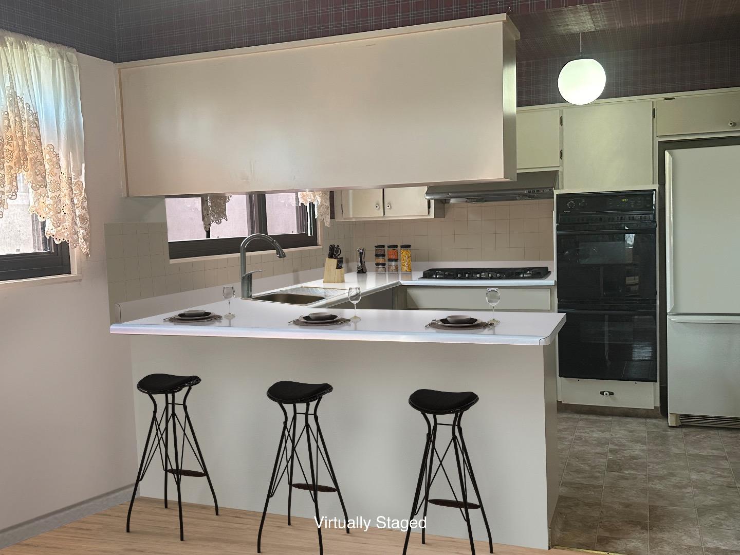 254 Sunshine Drive Pacifica, CA 94044 - Photo 3 of 5 a kitchen with stainless steel appliances a table and chairs in it