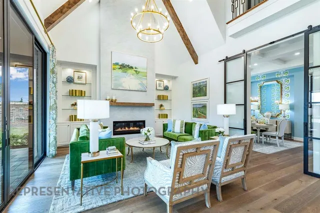 a living room with fireplace furniture and a large window