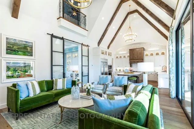 a living room with furniture fireplace and a large window