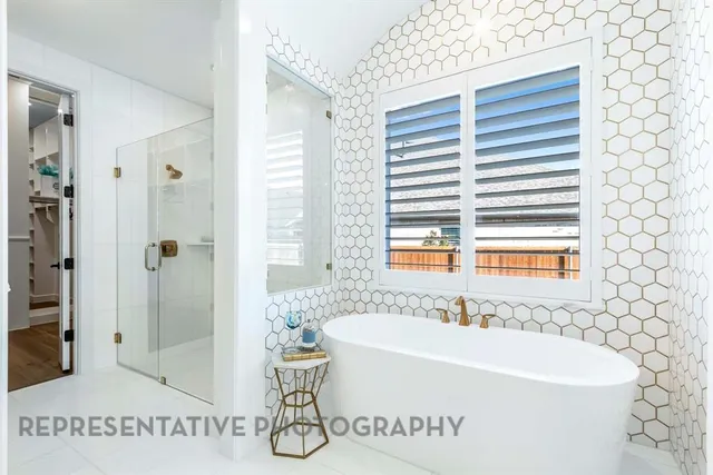 a white bath tub sitting next to a white sink