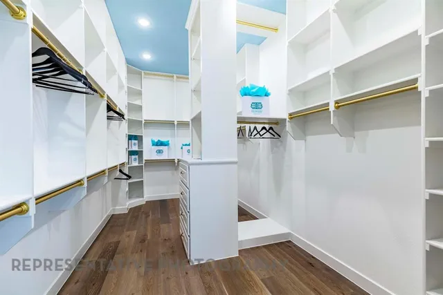 a hallway with wooden floor and staircase