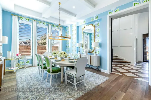 a dining room with furniture a chandelier and wooden floor